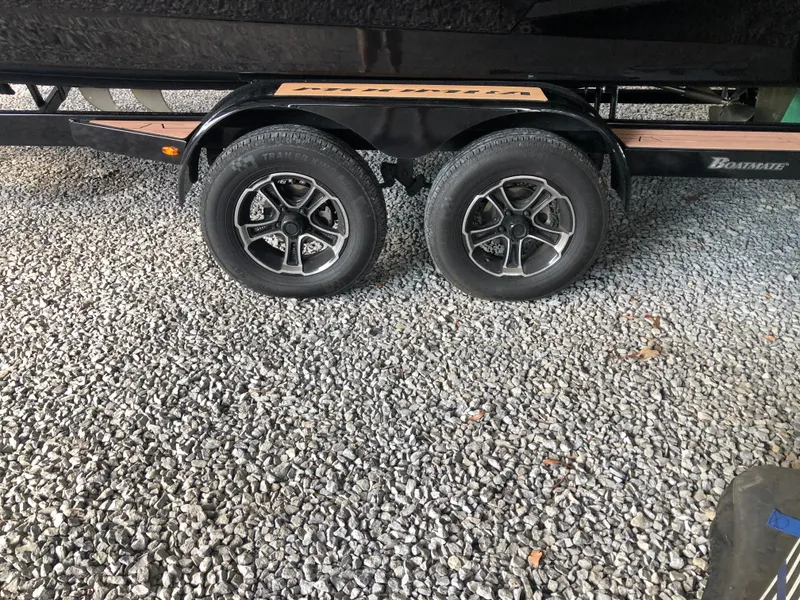Slide: The Image of 2023 Moomba Makai trailer wheels on gravel surface. - 11