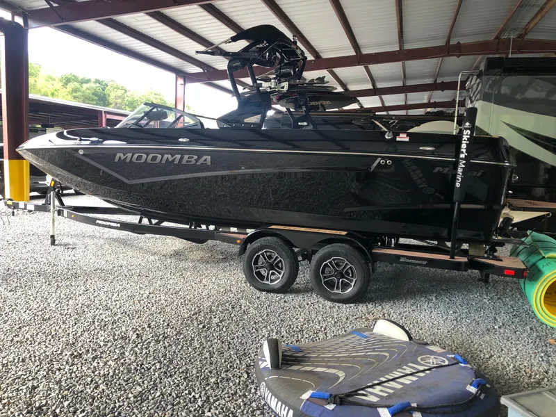 Slide: The Image of 2023 Moomba Makai boat on trailer in covered storage area. - 12