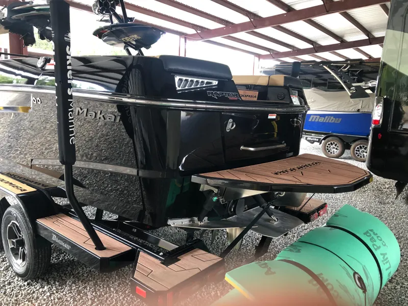 Slide: The Image of 2023 Moomba Makai boat on trailer in storage facility. - 13