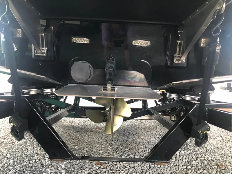 Slide: The Image of 2023 Moomba Makai boat propeller and hull detail on gravel surface. - 15