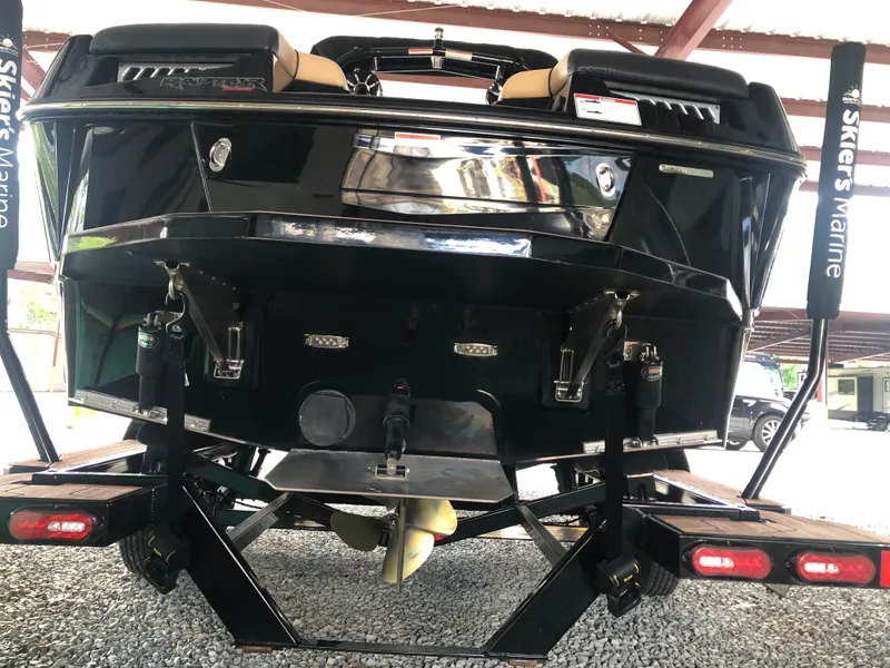 Slide: The Image of 2023 Moomba Makai boat rear view, showcasing sleek design and trailer setup. - 16