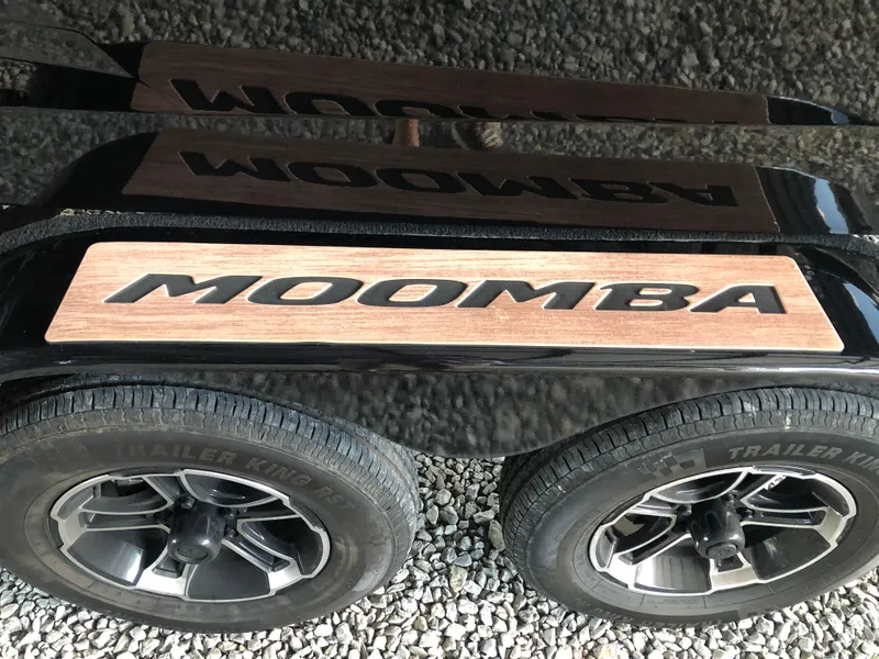 Slide: The Image of 2023 Moomba Makai trailer with dual wheels on gravel surface. - 17