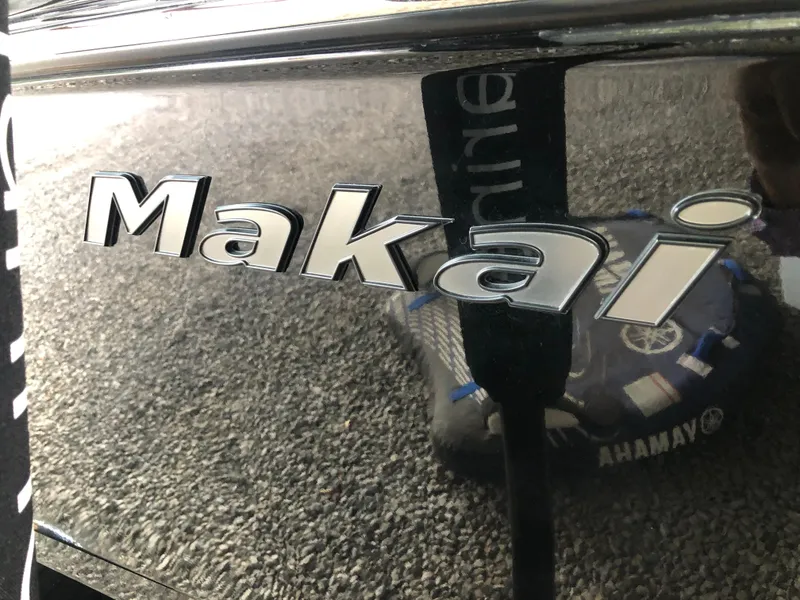Slide: The Image of 2023 Moomba Makai logo on a sleek black surface. - 21