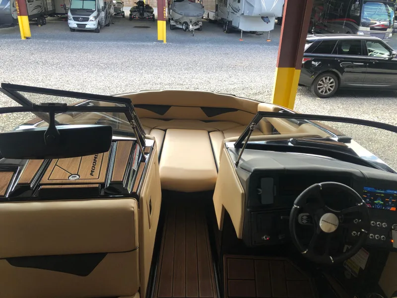 Slide: The Image of 2023 Moomba Makai boat interior with tan seating and modern dashboard. - 25