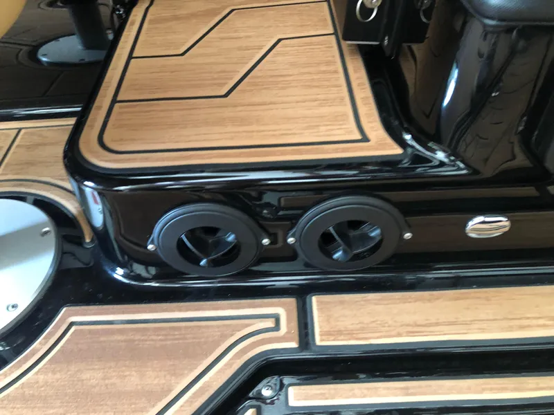 Slide: The Image of 2023 Moomba Makai boat interior with wood accents and black detailing. - 27