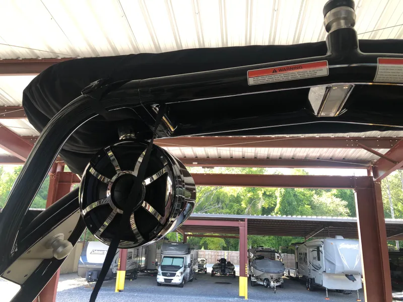 Slide: The Image of 2023 Moomba Makai boat speaker under covered storage with RVs in background. - 29