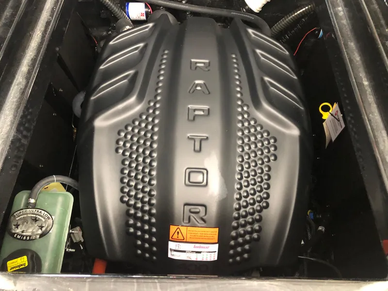 Slide: The Image of 2023 Moomba Makai Raptor engine, black cover with textured design. - 32