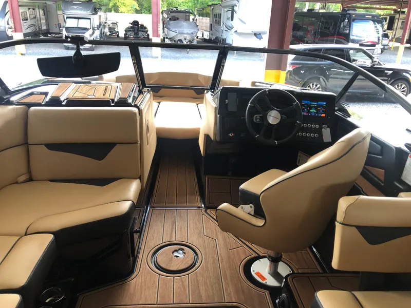 Slide: The Image of 2023 Moomba Makai boat interior with tan seating and modern dashboard. - 34