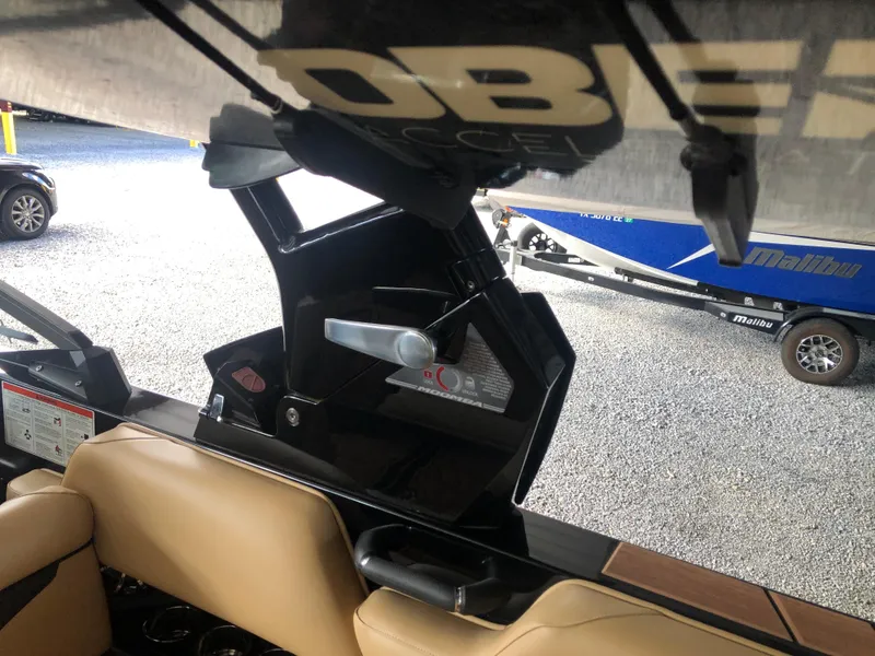 Slide: The Image of 2023 Moomba Makai boat interior with tan seats and adjustable wakeboard tower. - 35