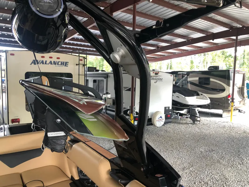Slide: The Image of 2023 Moomba Makai boat in storage, surrounded by RVs and trailers. - 36