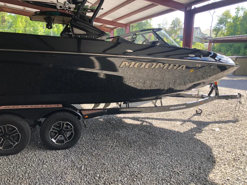 Slide: The Image of 2023 Moomba Makai boat on trailer in covered area, side view. - 4