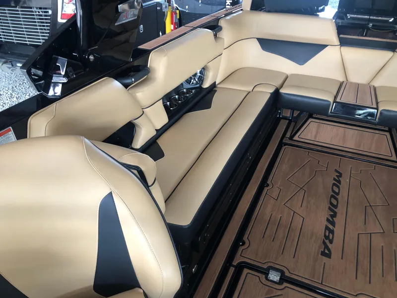 Slide: The Image of 2023 Moomba Makai boat interior with tan and black seating and branded flooring. - 41