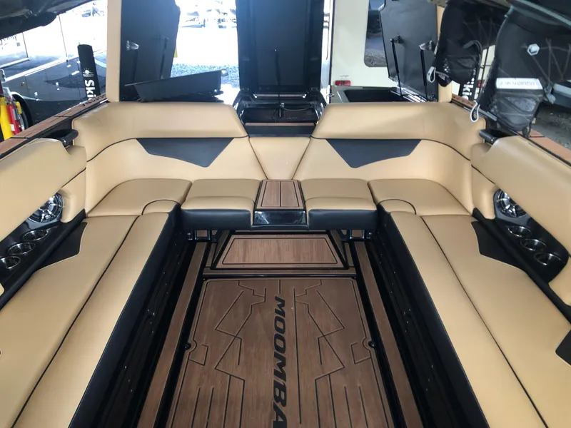 Slide: The Image of 2023 Moomba Makai boat interior with tan seating and wood flooring. - 42