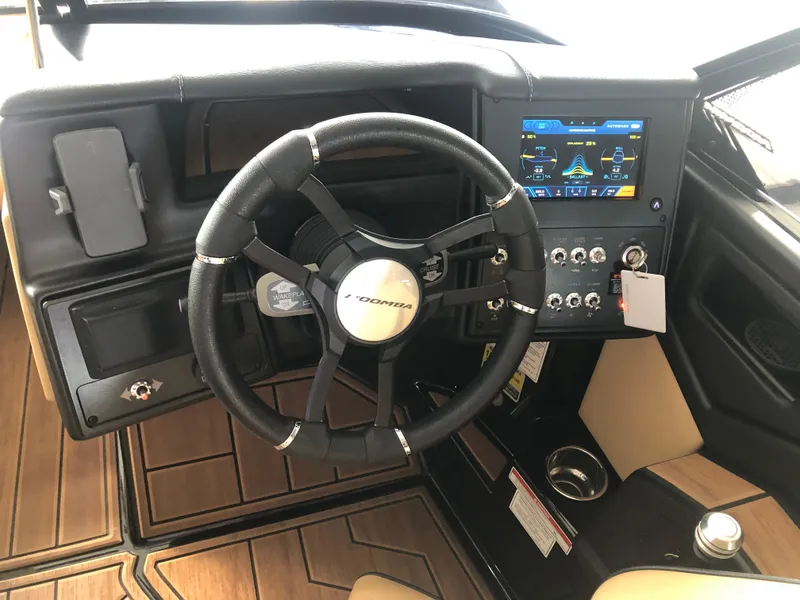 Slide: The Image of 2023 Moomba Makai boat dashboard with steering wheel and digital display. - 46