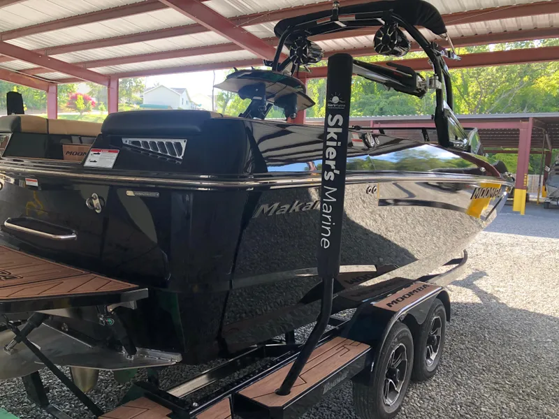 Slide: The Image of 2023 Moomba Makai boat on trailer under a metal canopy. - 7