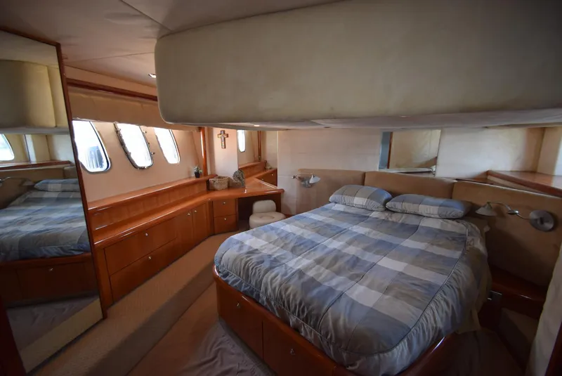 Slide: The Image of Luxurious bedroom interior of 2005 Sunseeker Manhattan 50 yacht with large bed and wooden cabinetry. - 15