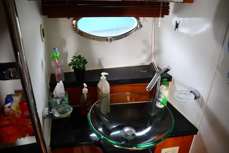 Slide: The Image of Sunseeker Manhattan 50 2005 yacht bathroom with glass sink and porthole window. - 16