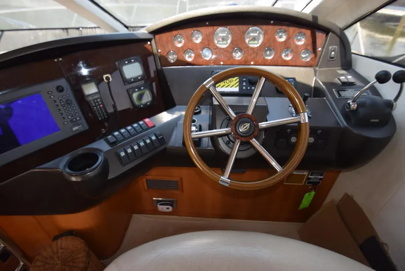 Slide: The Image of Helm of 2005 Sunseeker Manhattan 50 yacht with wooden steering wheel and control panel. - 20