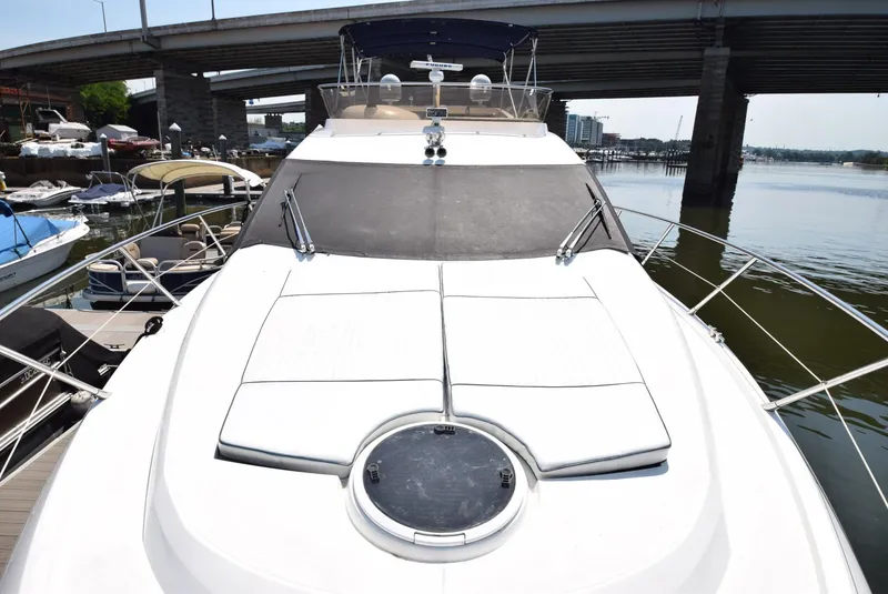 Slide: The Image of 2005 Sunseeker Manhattan 50 yacht docked near a bridge. - 25
