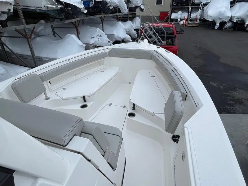 Slide: The Image of 2024 Pursuit S 248 Sport boat with spacious seating and storage compartments. - 10