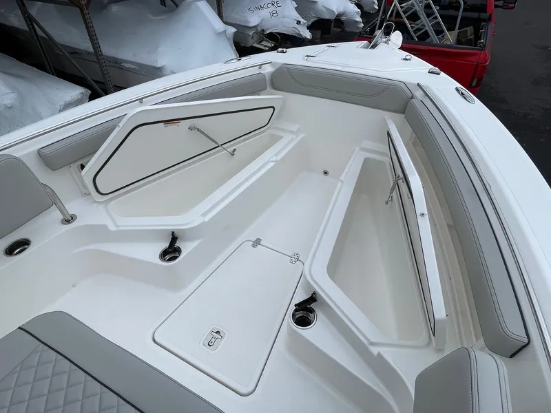Slide: The Image of 2024 Pursuit S 248 Sport boat interior with open storage compartments. - 11