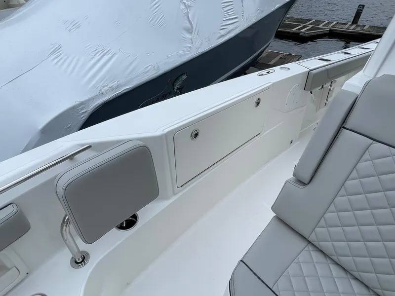 Slide: The Image of 2024 Pursuit S 248 Sport boat interior with white and gray seating. - 15