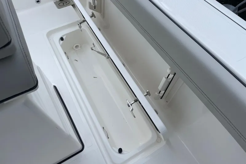 Slide: The Image of 2024 Pursuit S 248 Sport boat storage compartment with open lid. - 22