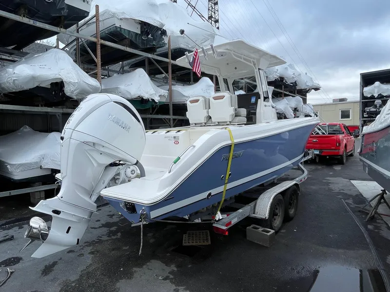 Slide: The Image of 2024 Pursuit S 248 Sport boat on a trailer in a marina. - 3