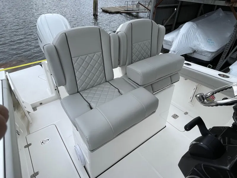Slide: The Image of 2024 Pursuit S 248 Sport boat with dual cushioned seats and diamond stitching. - 9