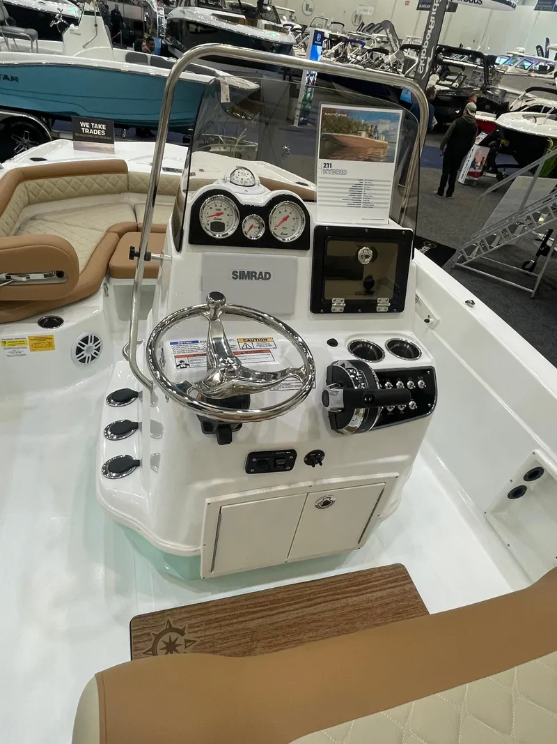 Slide: The Image of 2024 NauticStar 211 Hybrid boat dashboard with steering wheel and control panel. - 4