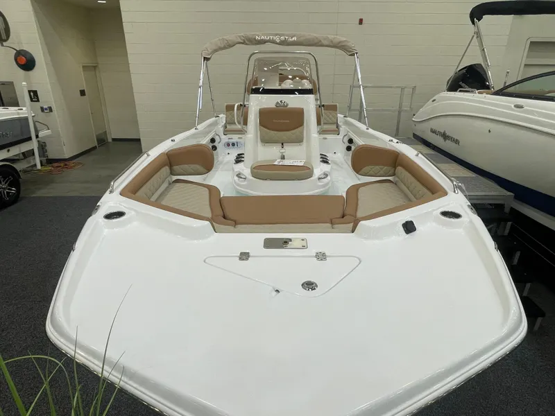 Slide: The Image of 2024 NauticStar 211 Hybrid boat with tan seating and white deck. - 6