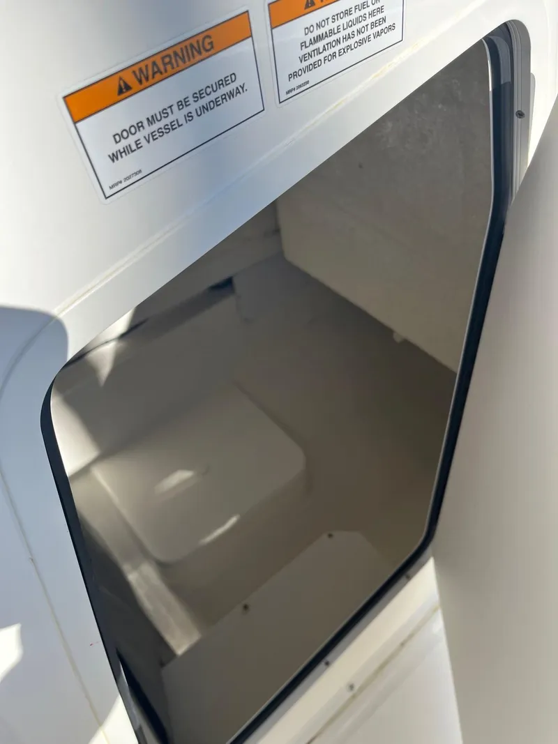 Slide: The Image of 2023 Bayliner Trophy T24 cabin interior with safety warning label. - 10