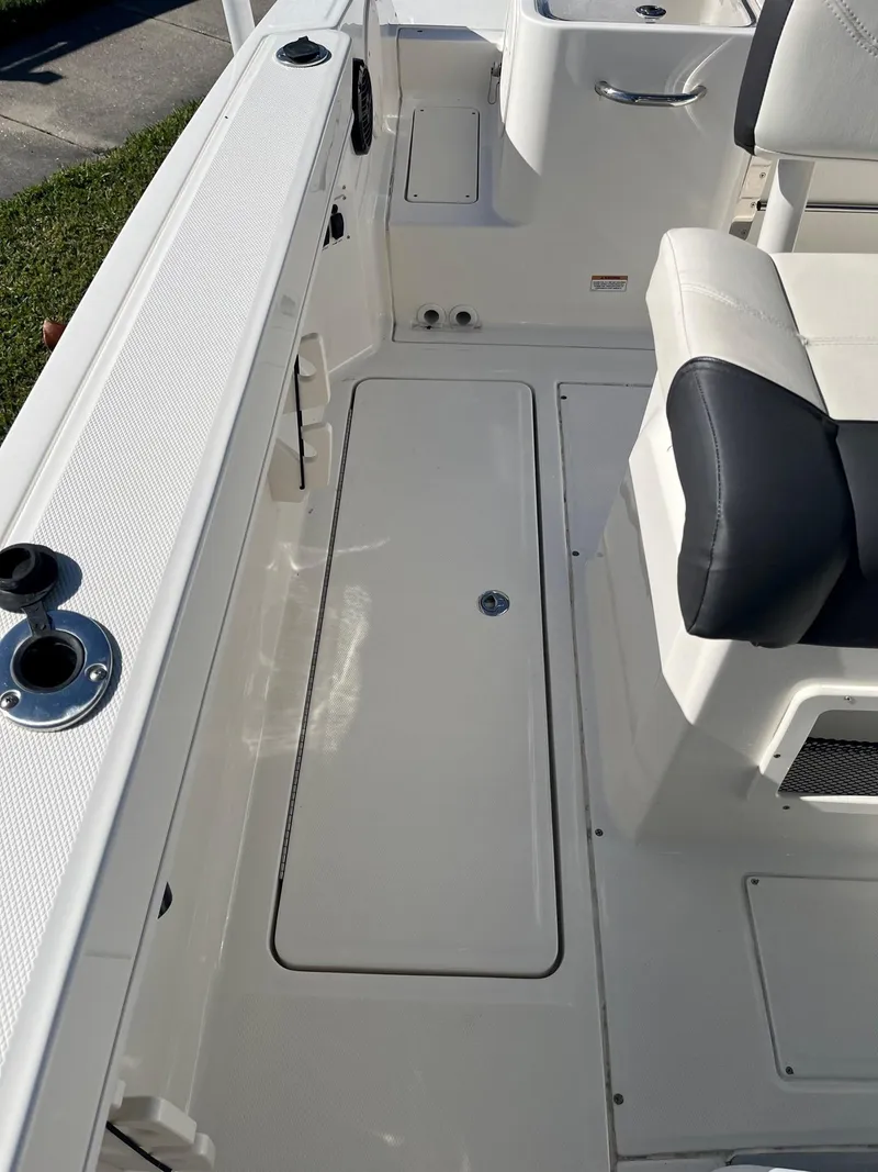 Slide: The Image of 2023 Bayliner Trophy T24 boat interior with seating and storage compartments. - 12