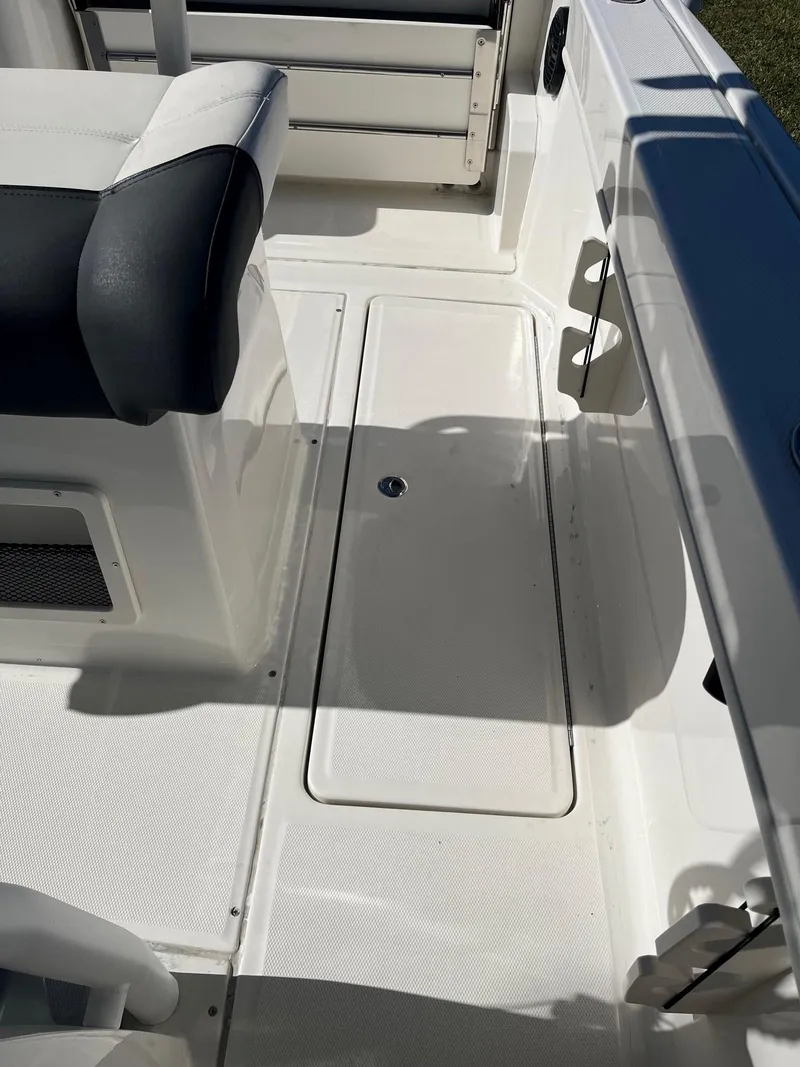Slide: The Image of 2023 Bayliner Trophy T24 boat deck with seating and storage compartment. - 14