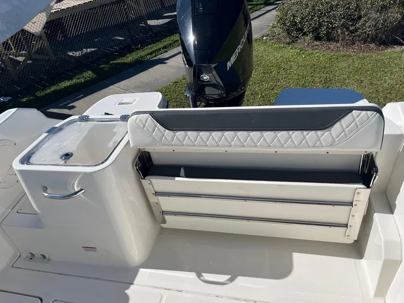 Slide: The Image of 2023 Bayliner Trophy T24 boat interior with seating and motor. - 16