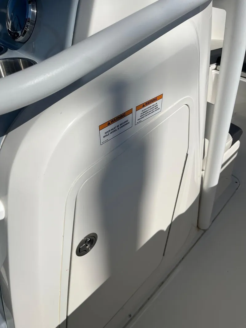 Slide: The Image of 2023 Bayliner Trophy T24 boat interior with control panel and safety labels. - 17