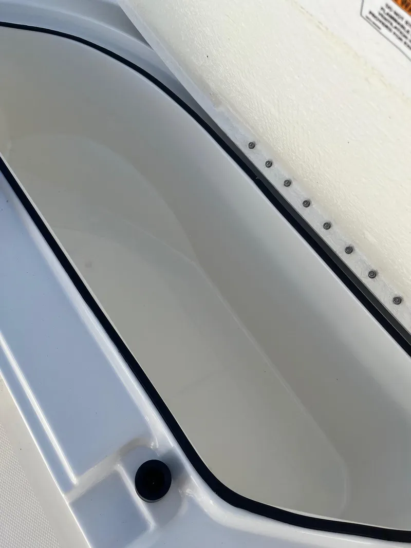 Slide: The Image of 2023 Bayliner Trophy T24 boat storage compartment, white interior, close-up view. - 5