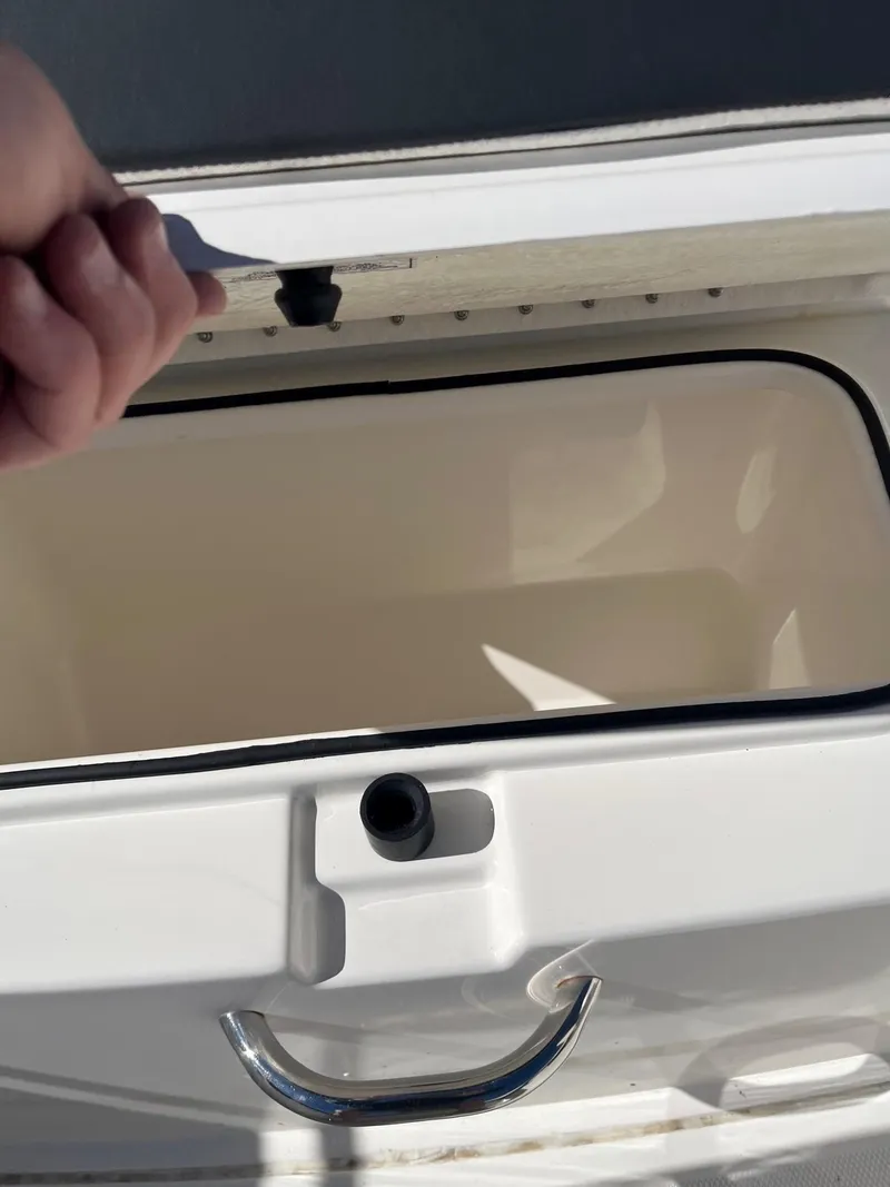 Slide: The Image of 2023 Bayliner Trophy T24 boat storage compartment with handle and latch. - 8
