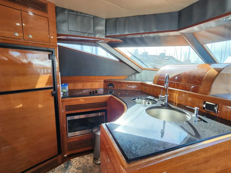 Slide: The Image of Luxurious 2007 Ocean Alexander Veloce yacht kitchen with modern amenities and sleek wood finishes. - 14