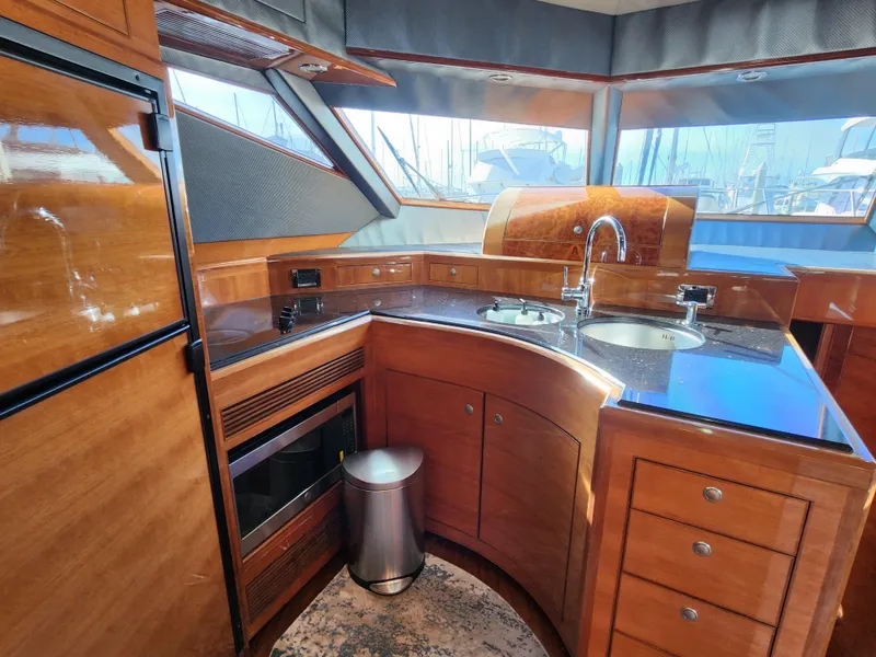 Slide: The Image of Luxurious 2007 Ocean Alexander Veloce yacht kitchen with wood cabinetry and modern appliances. - 15