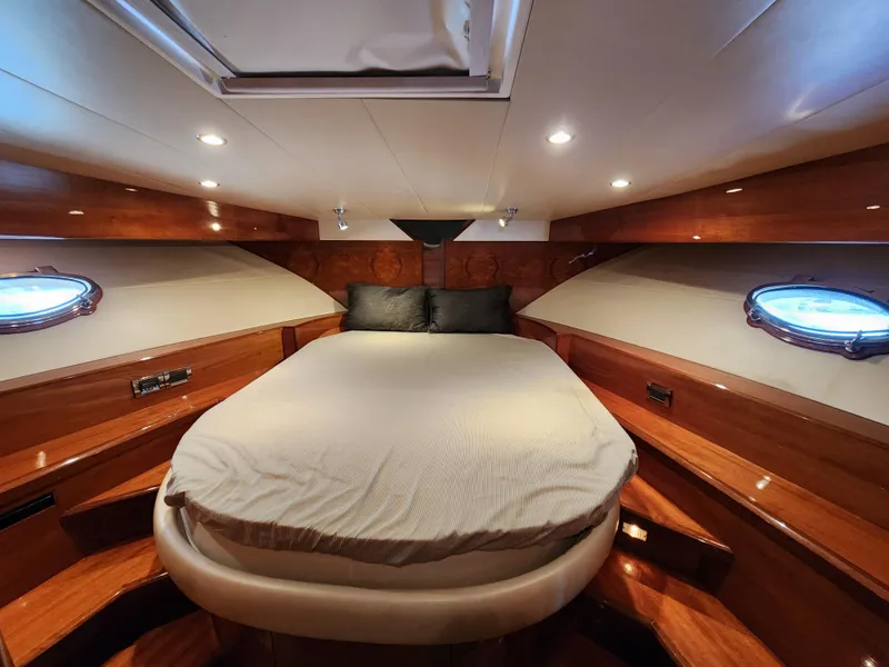 Slide: The Image of Luxurious 2007 Ocean Alexander Veloce yacht cabin with elegant wood finish and cozy bedding. - 16