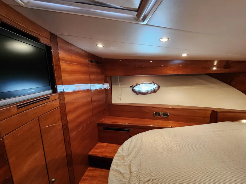 Slide: The Image of Luxurious 2007 Ocean Alexander Veloce yacht cabin with wood paneling and porthole window. - 18