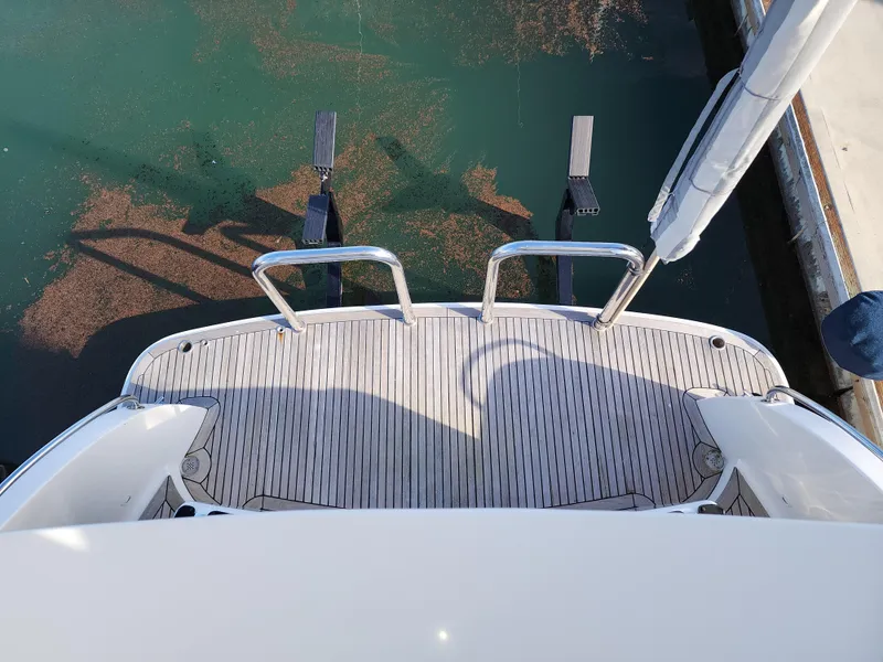 Slide: The Image of 2007 Ocean Alexander Veloce yacht swim platform with stainless steel railings, docked in calm water. - 27