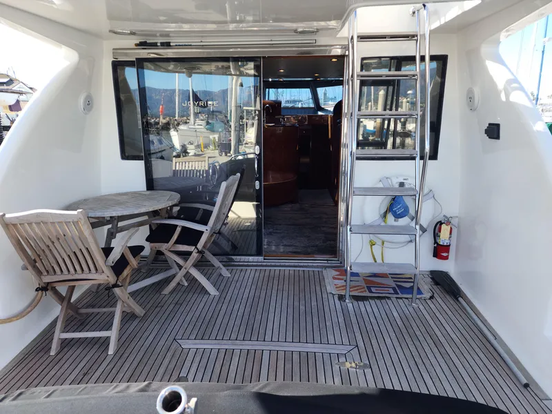 Slide: The Image of Outdoor deck of 2007 Ocean Alexander Veloce yacht with table, chairs, and ladder. - 47