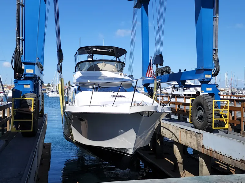 Slide: The Image of Ocean Alexander Veloce 2007 yacht in dry dock, blue sky, marina background. - 49