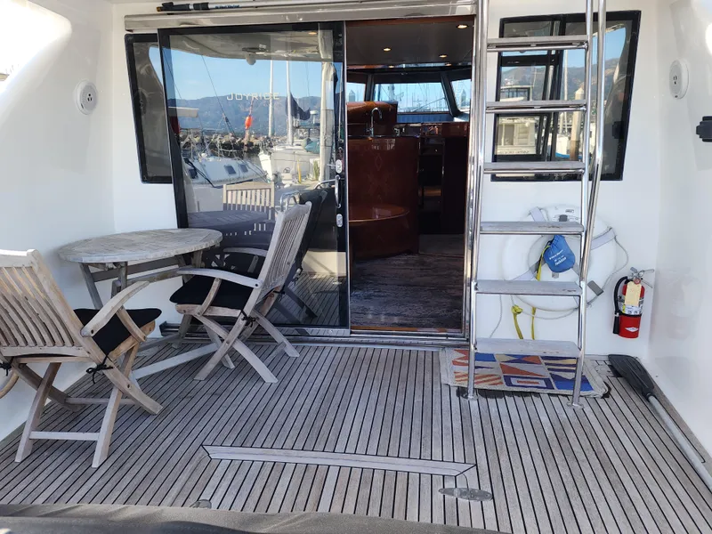 Slide: The Image of Ocean Alexander Veloce 2007 yacht deck with seating, table, and ladder. - 5