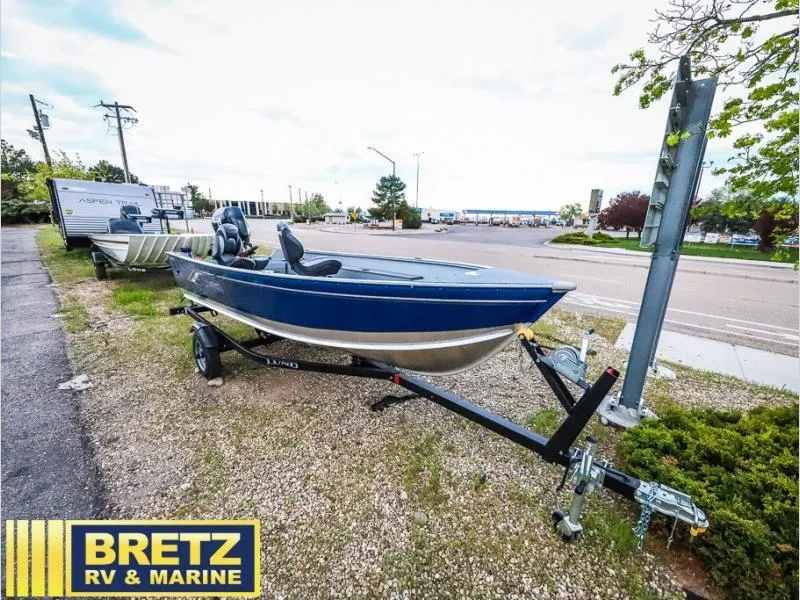 Slide: The Image of 2024 Fury 1400 Tiller boat on trailer at Bretz RV & Marine dealership. - 1