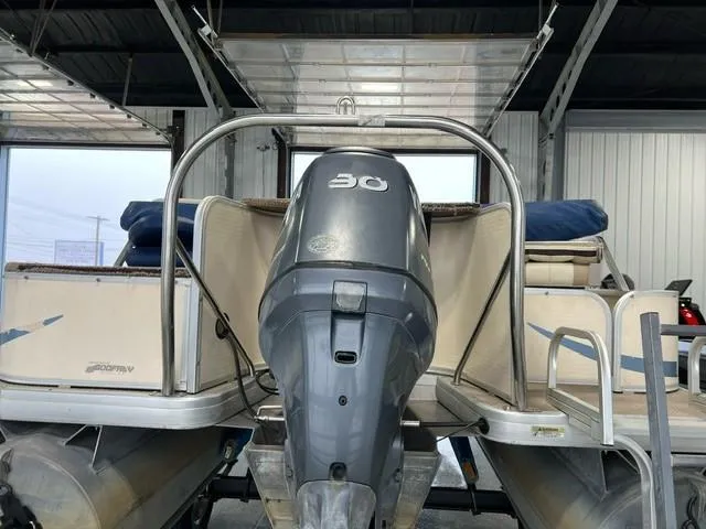 Slide: The Image of 2004 Godfrey F20 pontoon boat with 30 HP outboard motor in a garage. - 3