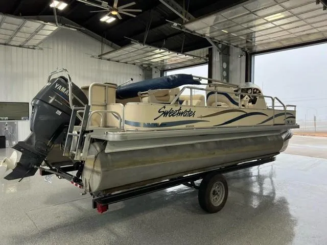 Slide: The Image of 2004 Godfrey Sweetwater F20 pontoon boat with Yamaha motor in a garage. - 4