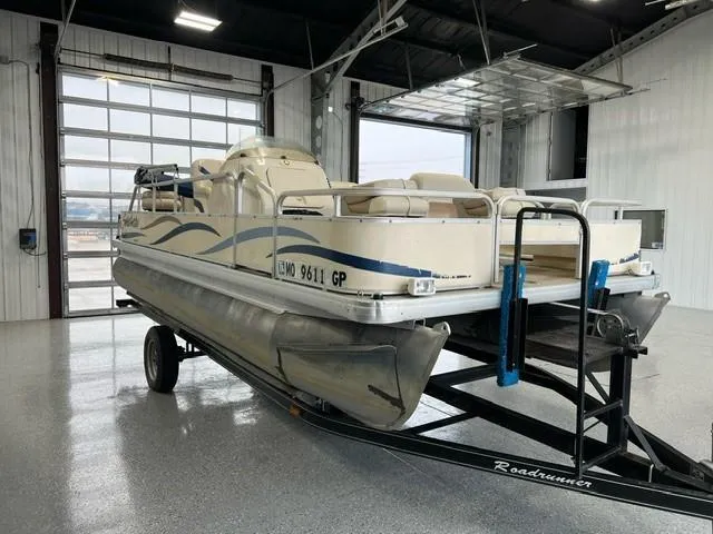 Slide: The Image of 2004 Godfrey F20 pontoon boat on trailer in a garage. - 5